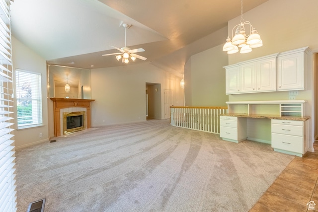 571 E Golden Pheasant Dr, Draper, UT 84020 - unfurnished living room with high vaulted ceiling, a chandelier, a tile fireplace, ceiling fan, and light carpet
