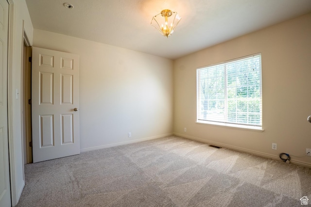 571 E Golden Pheasant Dr, Draper, UT 84020 - carpeted empty room with baseboards and a chandelier