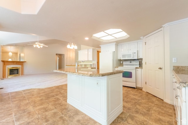 571 E Golden Pheasant Dr, Draper, UT 84020 - kitchen featuring white appliances, ceiling fan, white cabinets, a fireplace, and light tile patterned floors