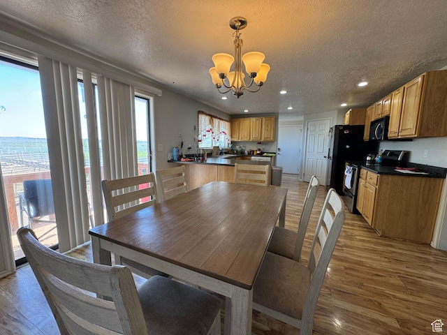 631 W Main St W, Wellington, UT 84542 - dining room featuring a chandelier, light wood-style flooring, a textured ceiling, and recessed lighting