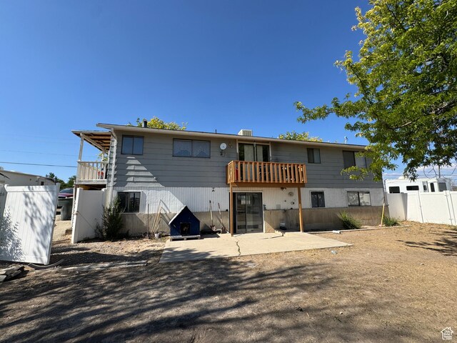 631 W Main St W, Wellington, UT 84542 - rear view of house featuring a balcony and a patio area
