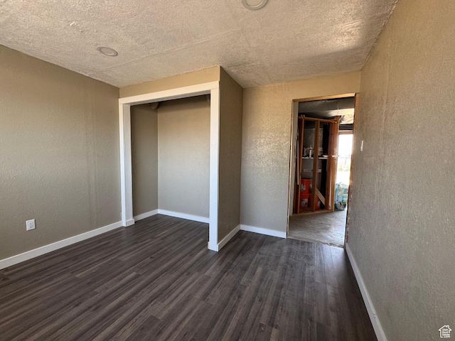 631 W Main St W, Wellington, UT 84542 - unfurnished bedroom featuring a textured wall, dark wood-type flooring, a textured ceiling, and a closet