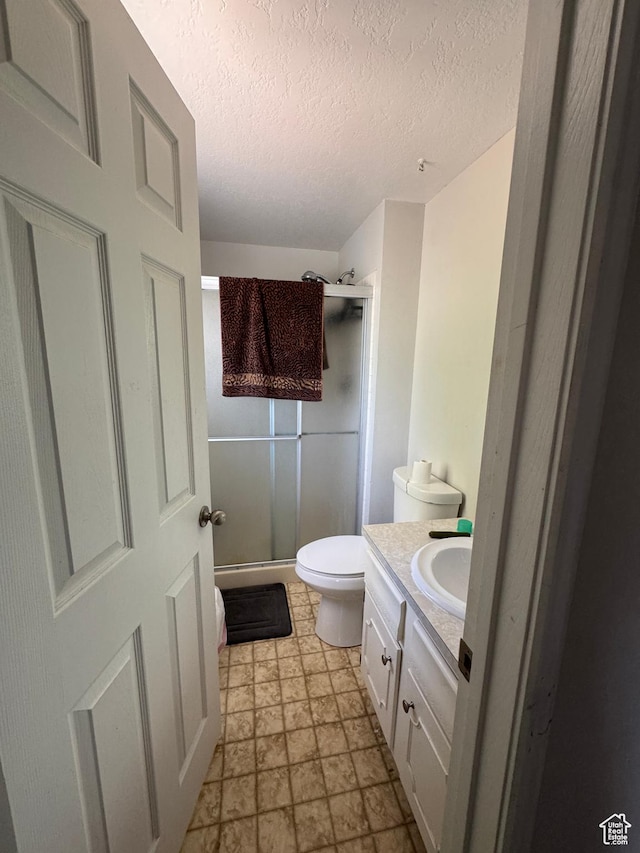 631 W Main St W, Wellington, UT 84542 - bathroom featuring a shower stall, vanity, a textured ceiling, and stone finish floors