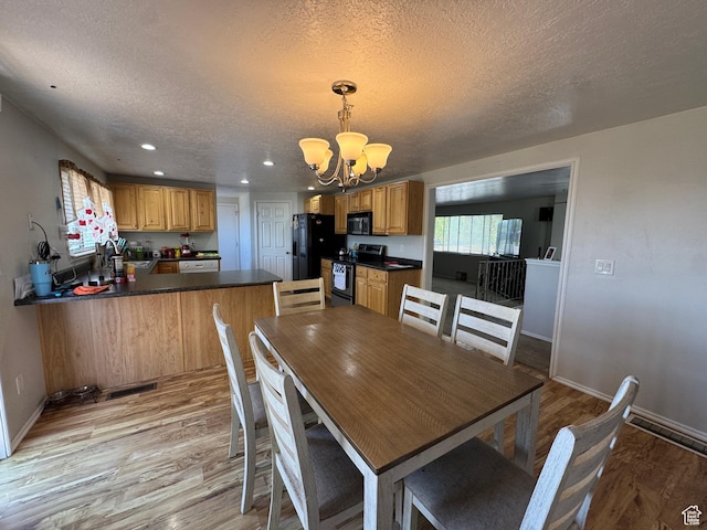 631 W Main St W, Wellington, UT 84542 - dining area featuring a chandelier, a textured ceiling, light wood-type flooring, and recessed lighting