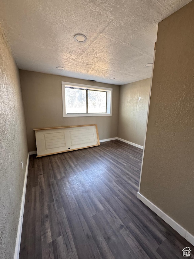 631 W Main St W, Wellington, UT 84542 - spare room featuring a textured wall, a textured ceiling, and dark wood finished floors