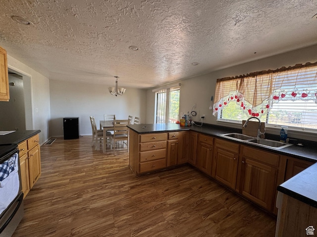 631 W Main St W, Wellington, UT 84542 - kitchen featuring black electric range, a textured ceiling, dark wood finished floors, a chandelier, and dark countertops