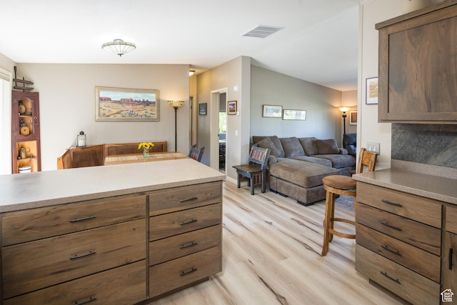 460 E Bowen Cir, Moab, UT 84532 - kitchen with light wood-style floors, open floor plan, light countertops, and vaulted ceiling