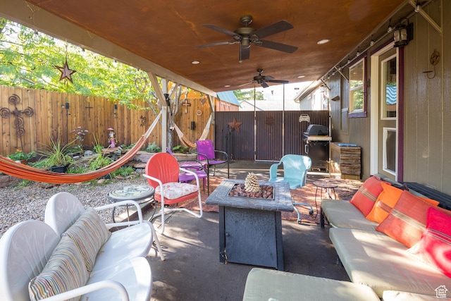 460 E Bowen Cir, Moab, UT 84532 - fenced backyard featuring an outdoor living space with a fire pit, a grill, a patio, and a ceiling fan