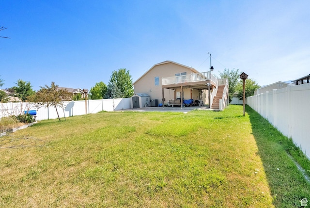 1047 W Ascot Dr N, North Salt Lake, UT 84054 - fenced backyard featuring stairs, a patio, a storage unit, and a wooden deck