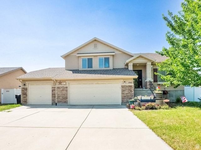 1047 W Ascot Dr N, North Salt Lake, UT 84054 - view of front of property featuring concrete driveway, stucco siding, an attached garage, and roof with shingles