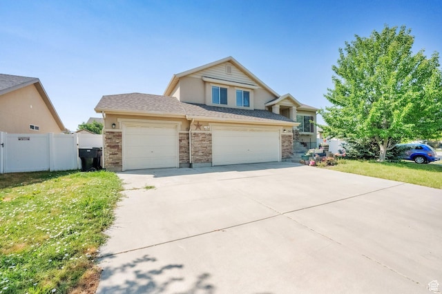 1047 W Ascot Dr N, North Salt Lake, UT 84054 - view of front of house with concrete driveway, brick siding, an attached garage, and a garage