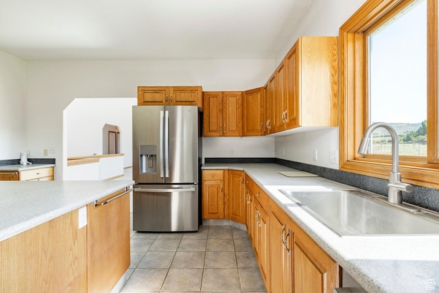3787 E 1200 S, Heber City, UT 84032 - kitchen featuring stainless steel refrigerator with ice dispenser, light countertops, light tile patterned flooring, and brown cabinets