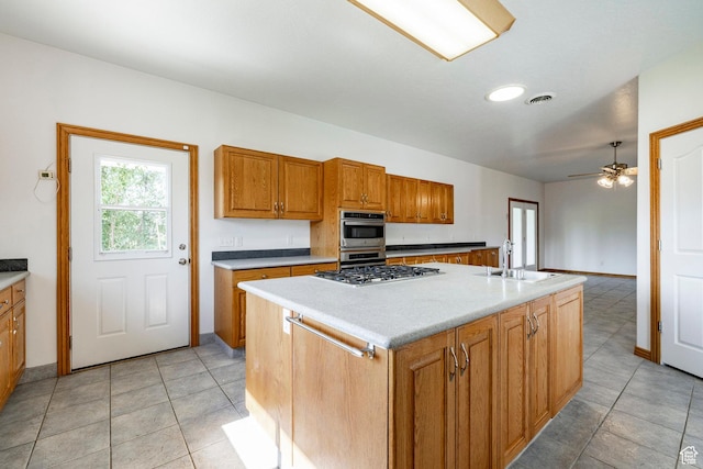 3787 E 1200 S, Heber City, UT 84032 - kitchen featuring stainless steel appliances, brown cabinetry, ceiling fan, and light tile patterned floors