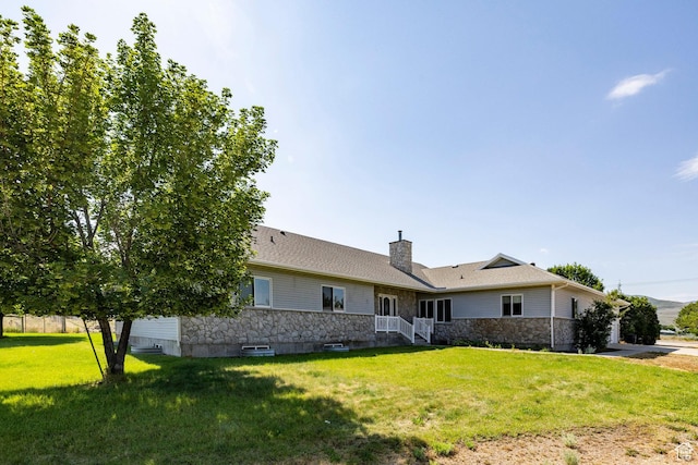 3787 E 1200 S, Heber City, UT 84032 - view of front of home featuring stone siding, a front lawn, a chimney, and a garage