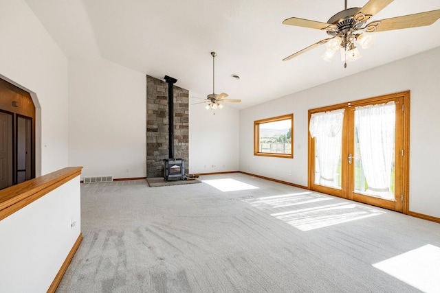 3787 E 1200 S, Heber City, UT 84032 - unfurnished living room with lofted ceiling, a wood stove, carpet floors, ceiling fan, and french doors