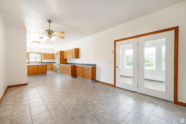 3787 E 1200 S, Heber City, UT 84032 - kitchen with brown cabinetry, light countertops, light tile patterned floors, and ceiling fan