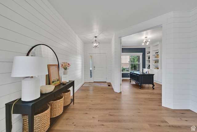 874 W Steeple Chase Dr, Kaysville, UT 84037 - foyer featuring a chandelier, light wood-style floors, and wooden walls