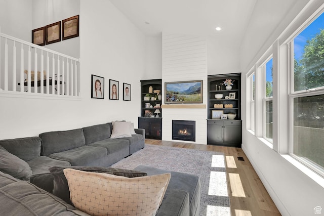 874 W Steeple Chase Dr, Kaysville, UT 84037 - living area with high vaulted ceiling, wood finished floors, a fireplace, recessed lighting, and built in features