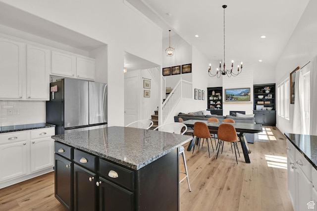 874 W Steeple Chase Dr, Kaysville, UT 84037 - kitchen with freestanding refrigerator, light wood-style floors, open floor plan, high vaulted ceiling, and white cabinets