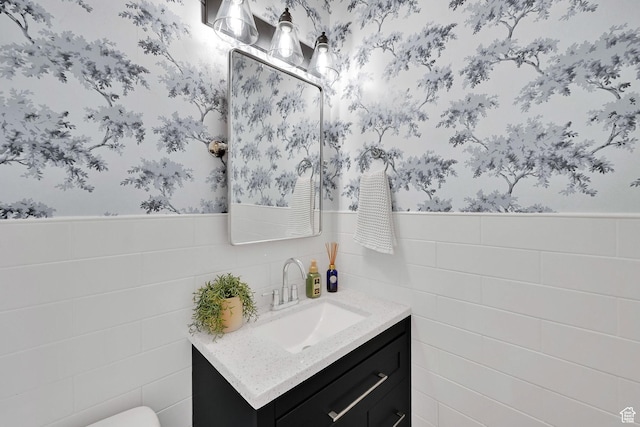 874 W Steeple Chase Dr, Kaysville, UT 84037 - bathroom with wallpapered walls, vanity, tile walls, and a wainscoted wall