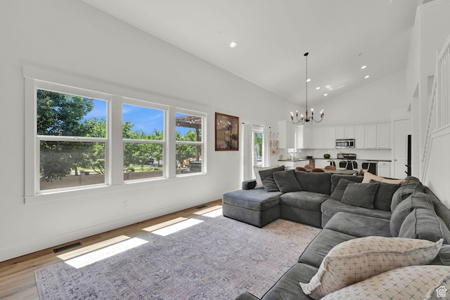 874 W Steeple Chase Dr, Kaysville, UT 84037 - living room featuring a chandelier, high vaulted ceiling, light wood-type flooring, and recessed lighting