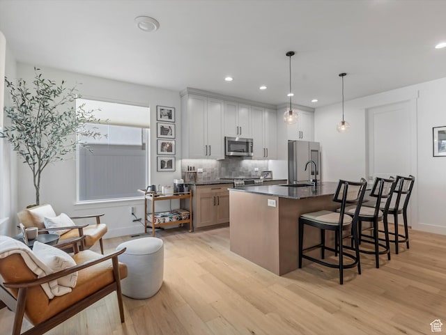 1783 E Bermondsey Ct, Holladay, UT 84117 - kitchen with stainless steel microwave, light wood-type flooring, high quality fridge, a breakfast bar area, and recessed lighting