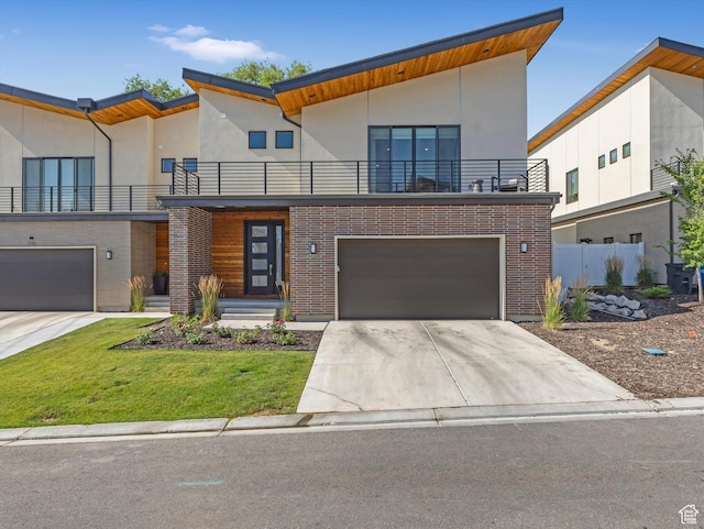 1783 E Bermondsey Ct, Holladay, UT 84117 - contemporary home featuring a balcony, brick siding, a garage, and concrete driveway