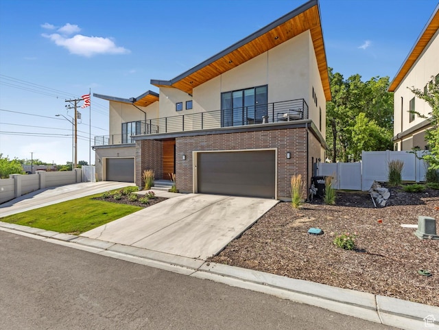1783 E Bermondsey Ct, Holladay, UT 84117 - modern home featuring a balcony, stucco siding, concrete driveway, and brick siding