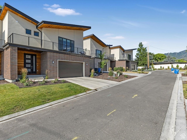 1783 E Bermondsey Ct, Holladay, UT 84117 - contemporary house featuring a balcony, stucco siding, driveway, a front yard, and a garage