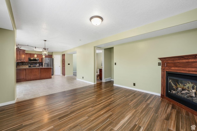 823 Creek Ln, Farmington, UT 84025 - unfurnished living room with wood finished floors and a glass covered fireplace