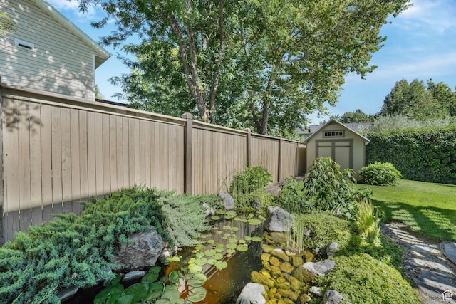 823 Creek Ln, Farmington, UT 84025 - view of yard with a storage unit and a small pond
