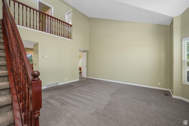 823 Creek Ln, Farmington, UT 84025 - unfurnished living room with carpet flooring, stairway, healthy amount of natural light, and a towering ceiling