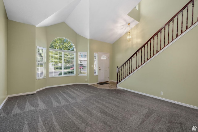 823 Creek Ln, Farmington, UT 84025 - foyer featuring carpet, high vaulted ceiling, stairway, and a chandelier