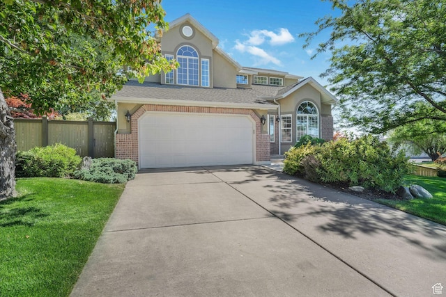 823 Creek Ln, Farmington, UT 84025 - traditional-style house with brick siding, driveway, stucco siding, and an attached garage