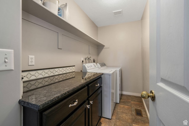 823 Creek Ln, Farmington, UT 84025 - washroom featuring washing machine and dryer, stone finish flooring, and cabinet space