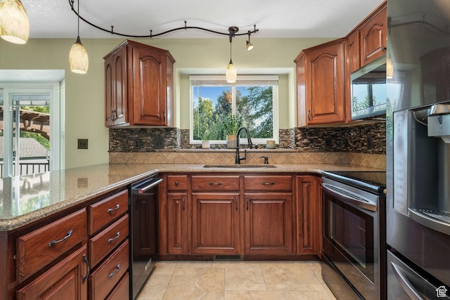 823 Creek Ln, Farmington, UT 84025 - kitchen featuring appliances with stainless steel finishes, light stone counters, decorative backsplash, and pendant lighting