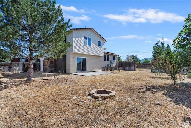 3221 W 6920 S, West Jordan, UT 84084 - back of house with an outdoor fire pit, a fenced backyard, and a patio