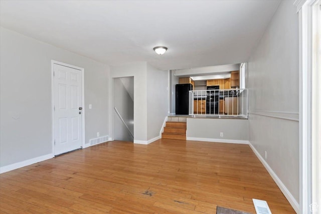 3221 W 6920 S, West Jordan, UT 84084 - unfurnished living room with light wood-style floors and baseboards