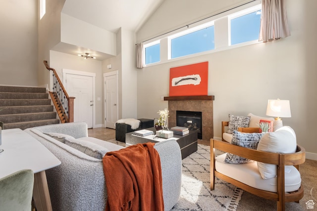 7873 S Farm House Ln E, Midvale, UT 84047 - living room featuring high vaulted ceiling, stairs, and a tile fireplace