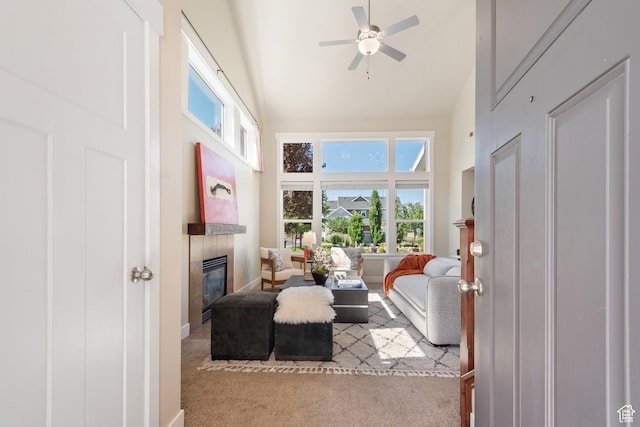 7873 S Farm House Ln E, Midvale, UT 84047 - carpeted living area with high vaulted ceiling, a tile fireplace, and a ceiling fan
