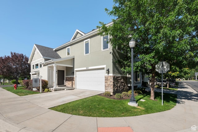 7873 S Farm House Ln E, Midvale, UT 84047 - view of front facade featuring stone siding, an attached garage, driveway, a front lawn, and stucco siding