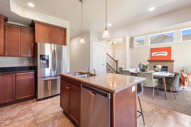 7873 S Farm House Ln E, Midvale, UT 84047 - kitchen featuring appliances with stainless steel finishes, a breakfast bar area, light tile patterned floors, stone countertops, and decorative light fixtures