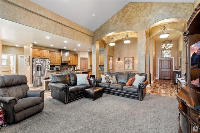 3695 S 3525 W, West Haven, UT 84401 - living room featuring arched walkways, a chandelier, high vaulted ceiling, light carpet, and recessed lighting
