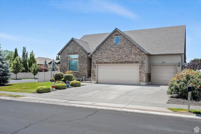 3695 S 3525 W, West Haven, UT 84401 - view of front facade featuring concrete driveway, stone siding, a garage, and stucco siding