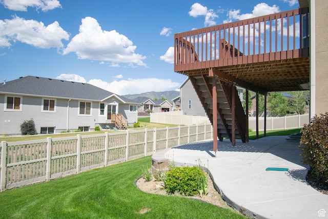 1233 E Upland Dr S Unit 112, Tooele, UT 84074 - fenced backyard with stairway, a patio area, a residential view, and a deck with mountain view