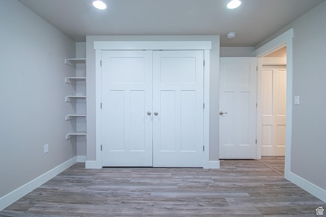 1233 E Upland Dr S Unit 112, Tooele, UT 84074 - unfurnished bedroom featuring a closet, recessed lighting, and wood finished floors