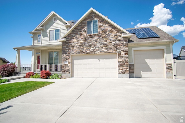 1233 E Upland Dr S Unit 112, Tooele, UT 84074 - view of front facade featuring stone siding, a porch, and solar panels