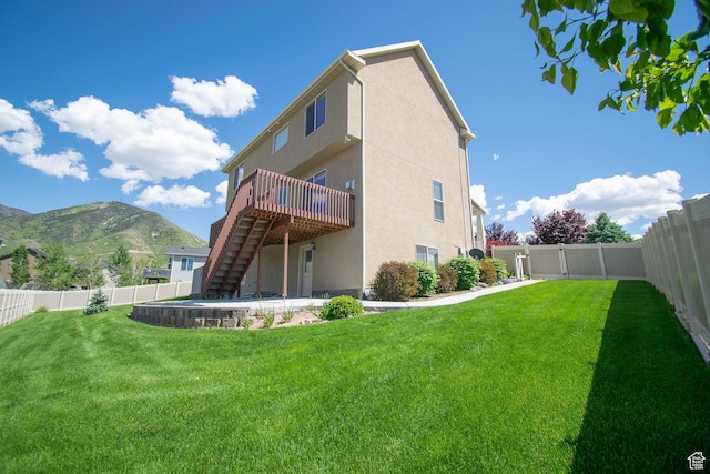 1233 E Upland Dr S Unit 112, Tooele, UT 84074 - back of house featuring stairway, a deck with mountain view, a fenced backyard, and stucco siding