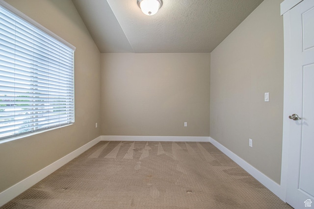 1233 E Upland Dr S Unit 112, Tooele, UT 84074 - bonus room featuring light carpet, vaulted ceiling, and a textured ceiling