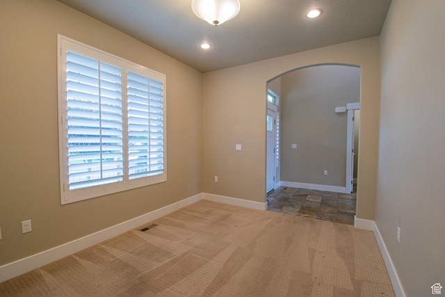 1233 E Upland Dr S Unit 112, Tooele, UT 84074 - empty room featuring arched walkways, carpet, and recessed lighting